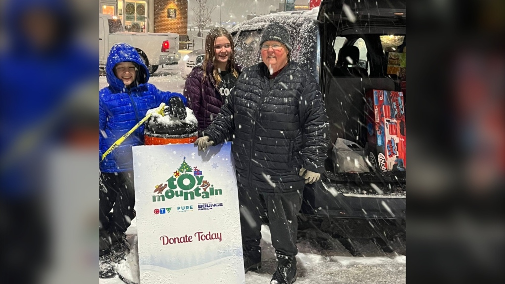 Volunteers with Simcoe Muskoka Family Connexions worked the CTV Barrie Toy Mountain drive-thru drop-off on Thursday evening as the snow fell at Park Place.