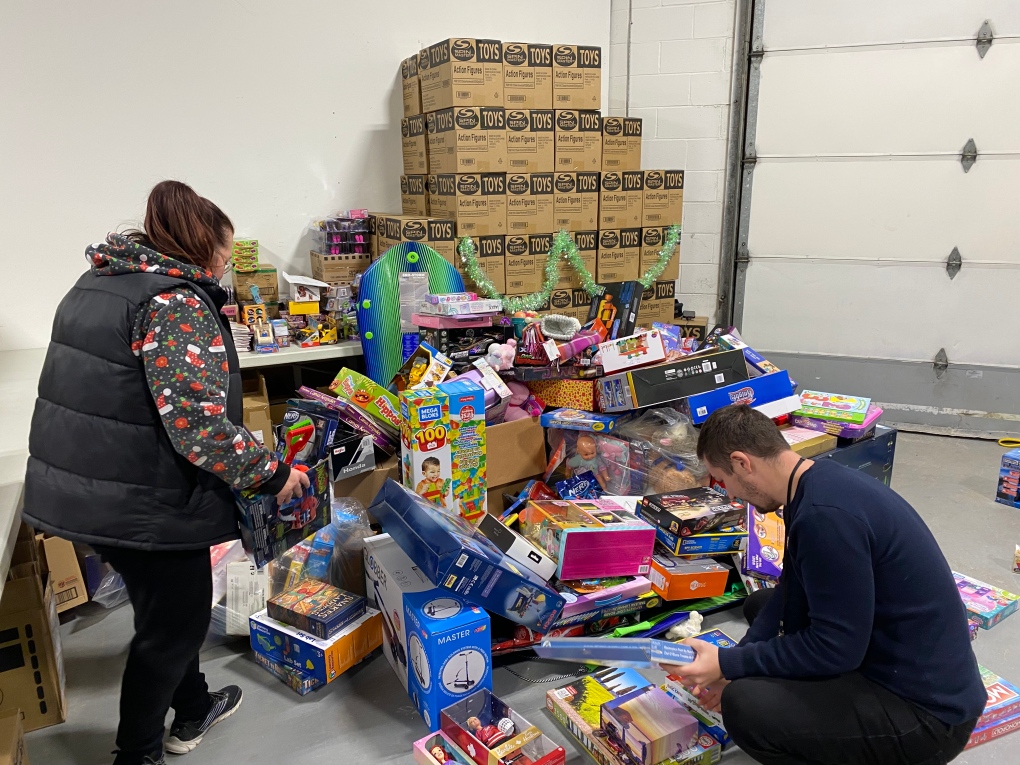 Volunteers with Simcoe Muskoka Family Connexions unload and sort donated toys at the holiday warehouse for the hundreds of families in need this holiday season.