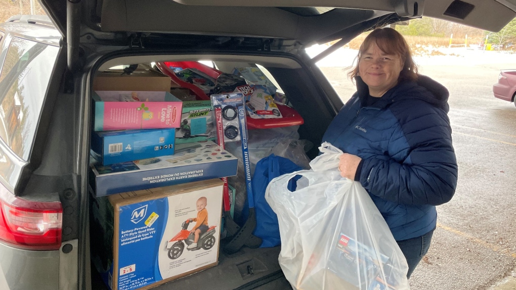 Family Connexions volunteer Jen finishes loading up one of two more van loads of toys.