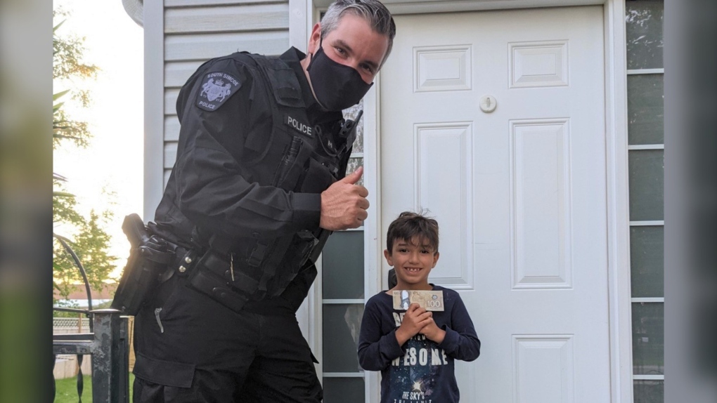 A police constable visited Oliver and rewarded him with the $100 bill for his honesty turning in the money that he had found so many months ago. (South Simcoe Police/SUBMITTED)