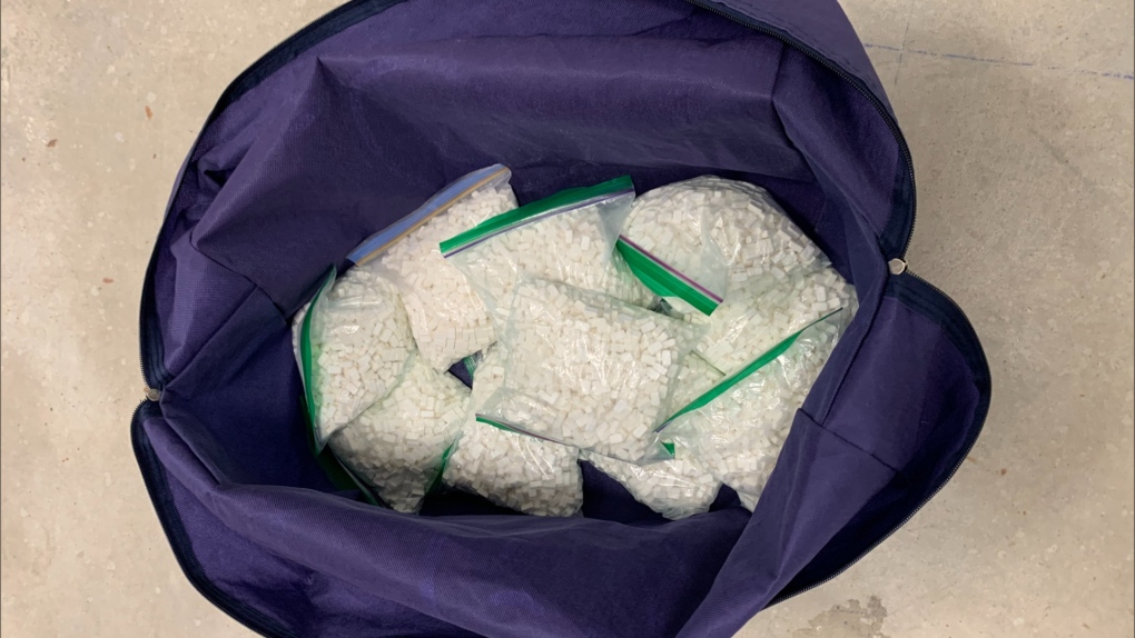 Police display ziplocked bags containing suspected methamphetamine that was allegedly seized in Barrie, Ont. on Mon. July 12, 2021 (Barrie Police Services)