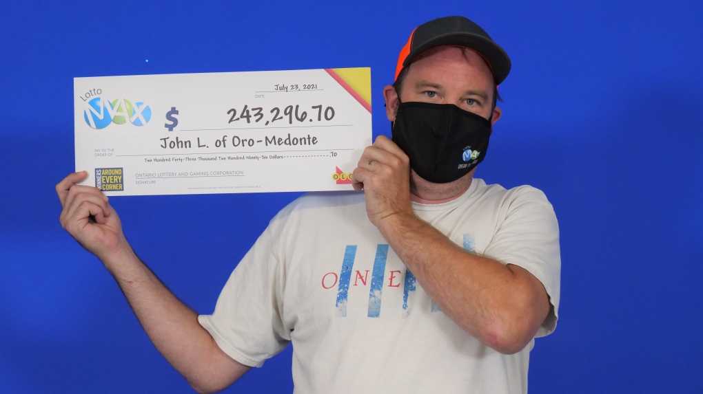 John Lloyd, 45, of Oro-Medonte, Ont., holds his cheque for $243,296.70 after winning a Lotto Max second prize in the July 16, 2021, draw. (OLG)