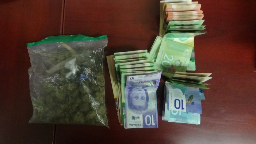 Huntsville OPP displays evidence of Canadian currency and cannabis allegedly seized during a traffic stop in Huntsville, Ont., on Tues., April 12, 2022 (SUPPLIED)