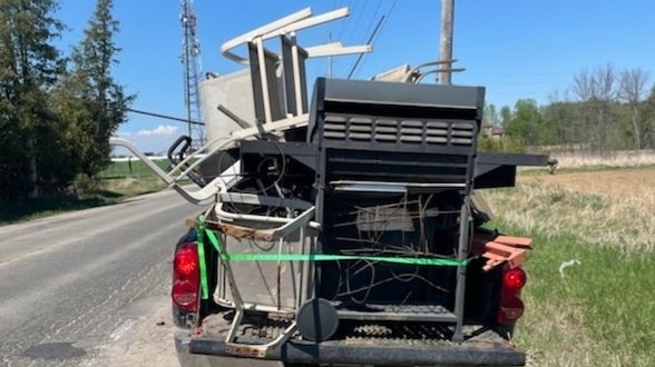 A truck is pulled over for having an unsafe load on Fri., May 13, 2022, in Innisfil, Ont. (SOUTH SIMCOE POLICE/TWITTER)