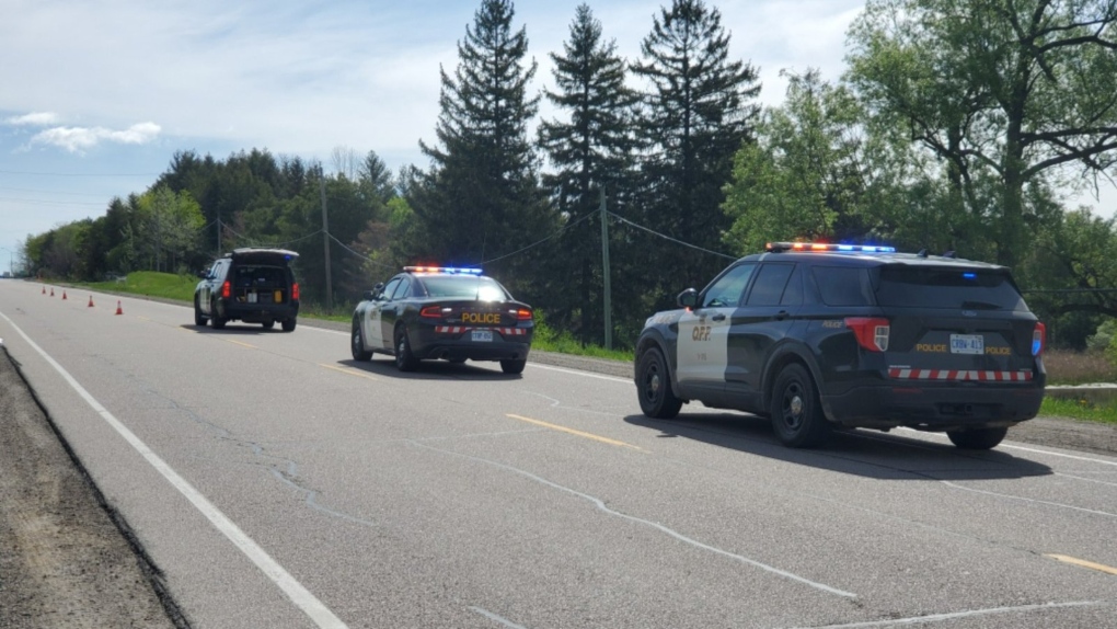 Police at the scene of a serious collision involving a bicycle and dump truck on Highway 9 in Caledon, Ont. on Wed., May 18, 2022 (OPP_CR/Twitter)