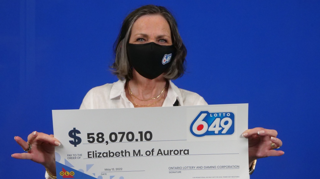 Elizabeth MacGillivray, of Aurora, Ont., holds her big cheque at the OLG Prize Centre in Toronto. (OLG)