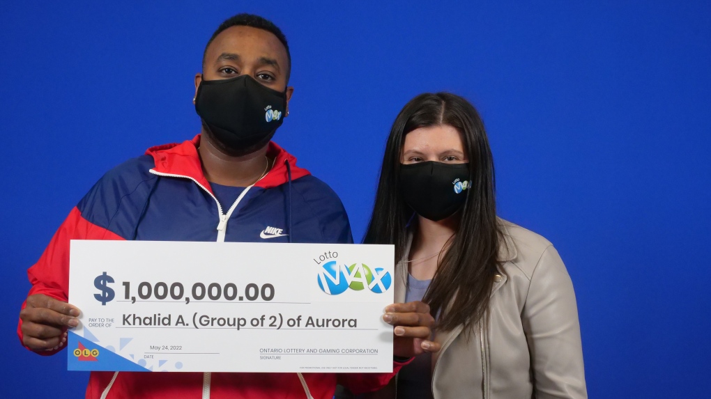 Khalid Ahmed and Marta Antoszko, of Aurora, Ont., hold the big cheque at the OLG Prize Centre in Toronto. (OLG)