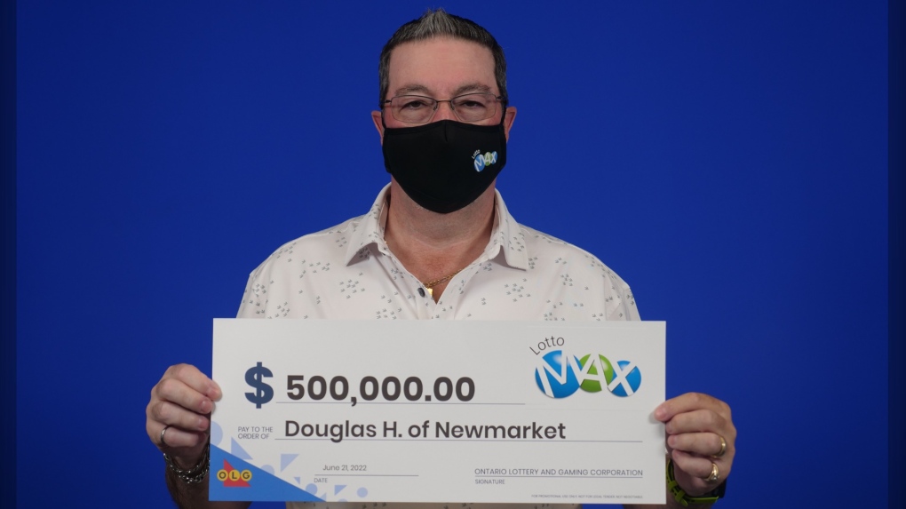 Douglas Heard of Newmarket, Ont. hold a winning cheque for $500,000 (Courtesy of OLG)