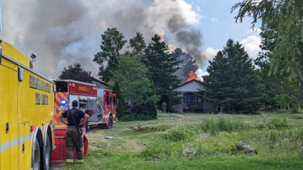 Emergency crews battle a house fire in Amaranth Township, Ont., on Thurs., July 7, 2022. (OPP_CR/Twitter)