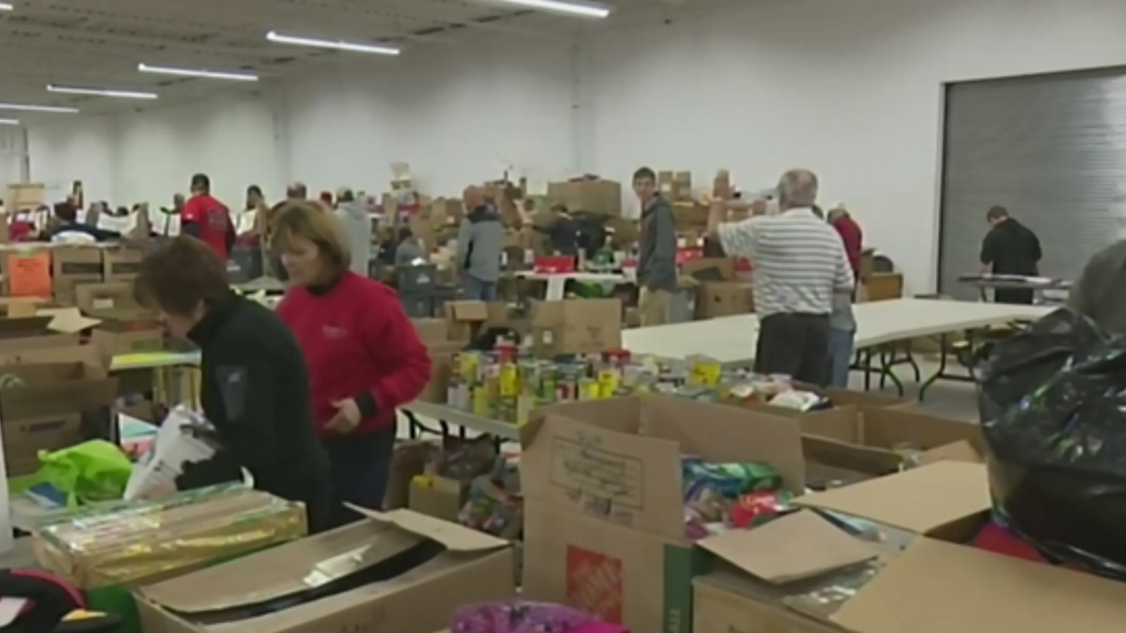Dozens of people pack boxes at Barrie & District's Christmas Cheer in this file image. Nov. 13, 2023 (CTV NEWS)