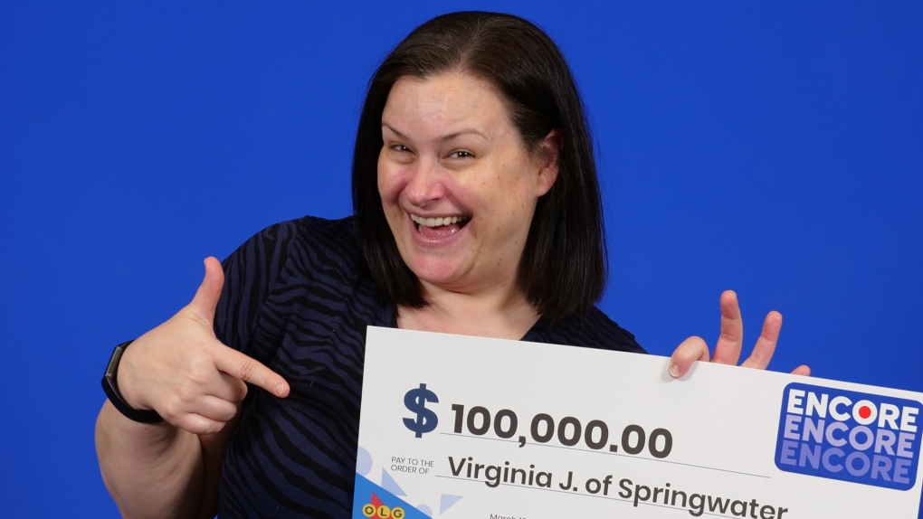 Virginia Jones, 48, of Springwater Township, Ont., holds her big cheque after winning with Encore in the Jan. 10, 2023, Lotto Max draw. (OLG)