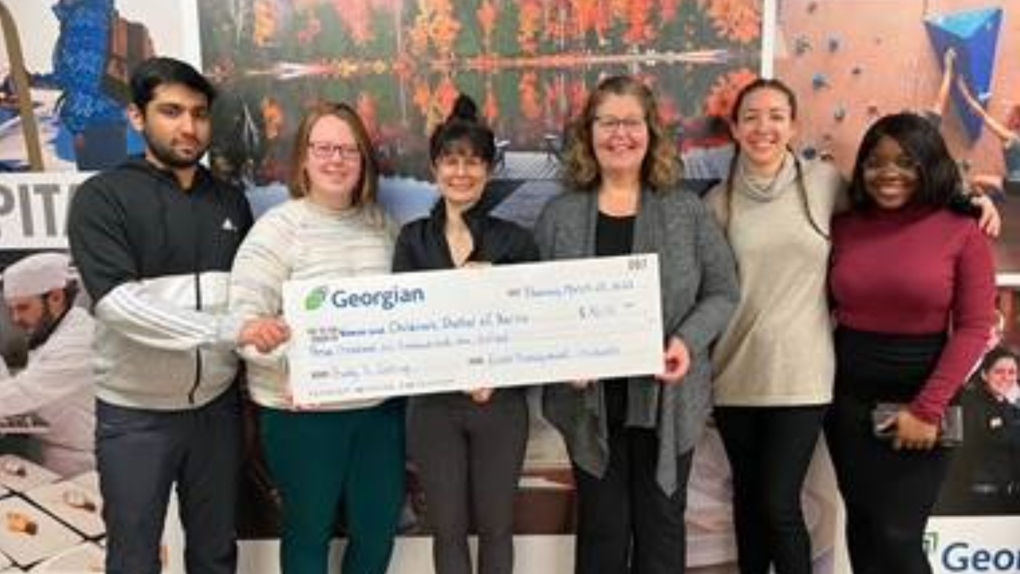 The Pretty ‘n Spring Garden Tea student planning team present a cheque for $3,600 to Deb James, Fund Development Manager for the Women & Children’s Shelter of Barrie. (Source: Georgian College)