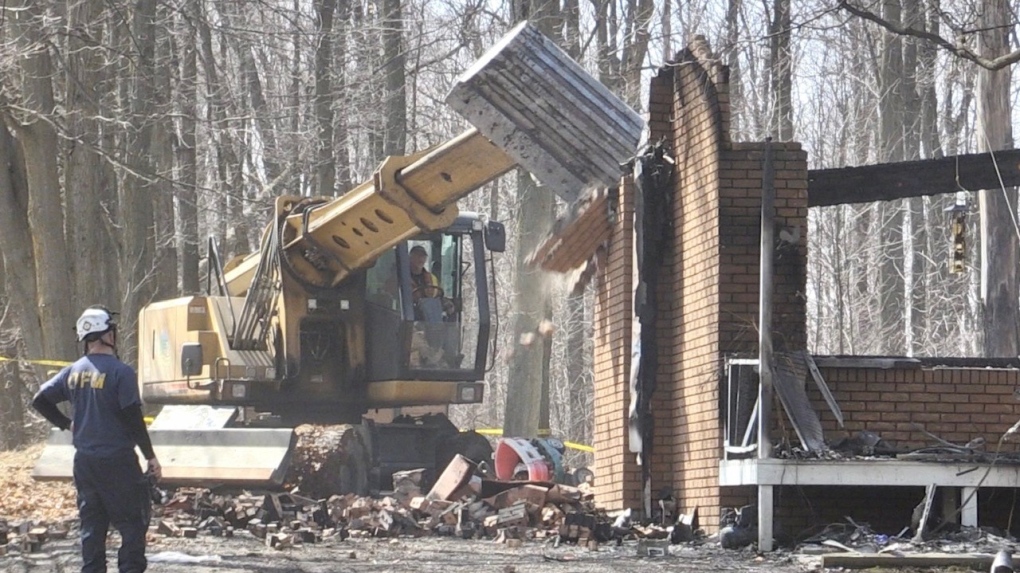 Crews work to clear the rubble after a house fire in Essa Township, Ont., on Sat., April 1, 2023. (Steve Mansbridge/CTV News). 