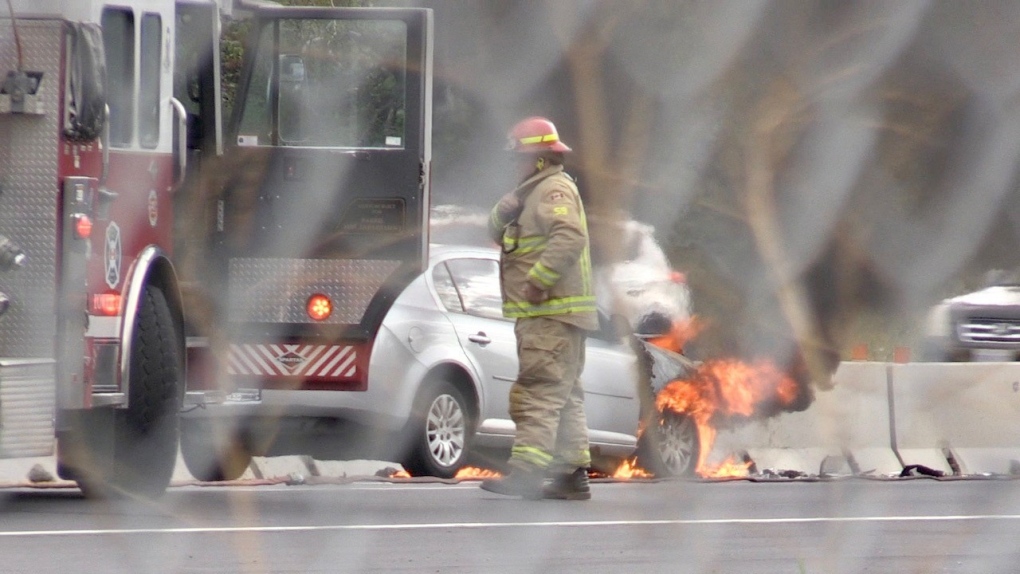 Firefighters tend to a vehicle fire on Highway 400, near Dunlop Street on Sun., Sept. 10 (Steve Mansbridge/CTV News). 