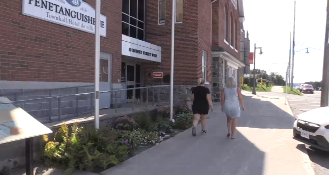 Two people walk in front of the Town Hall in Penetanguishene on Sept. 6, 2023 (Rowan Fleary/CTV News). 